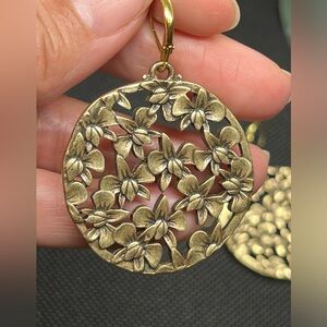 Vintage brassy toned orchid collage round dangle earrings.